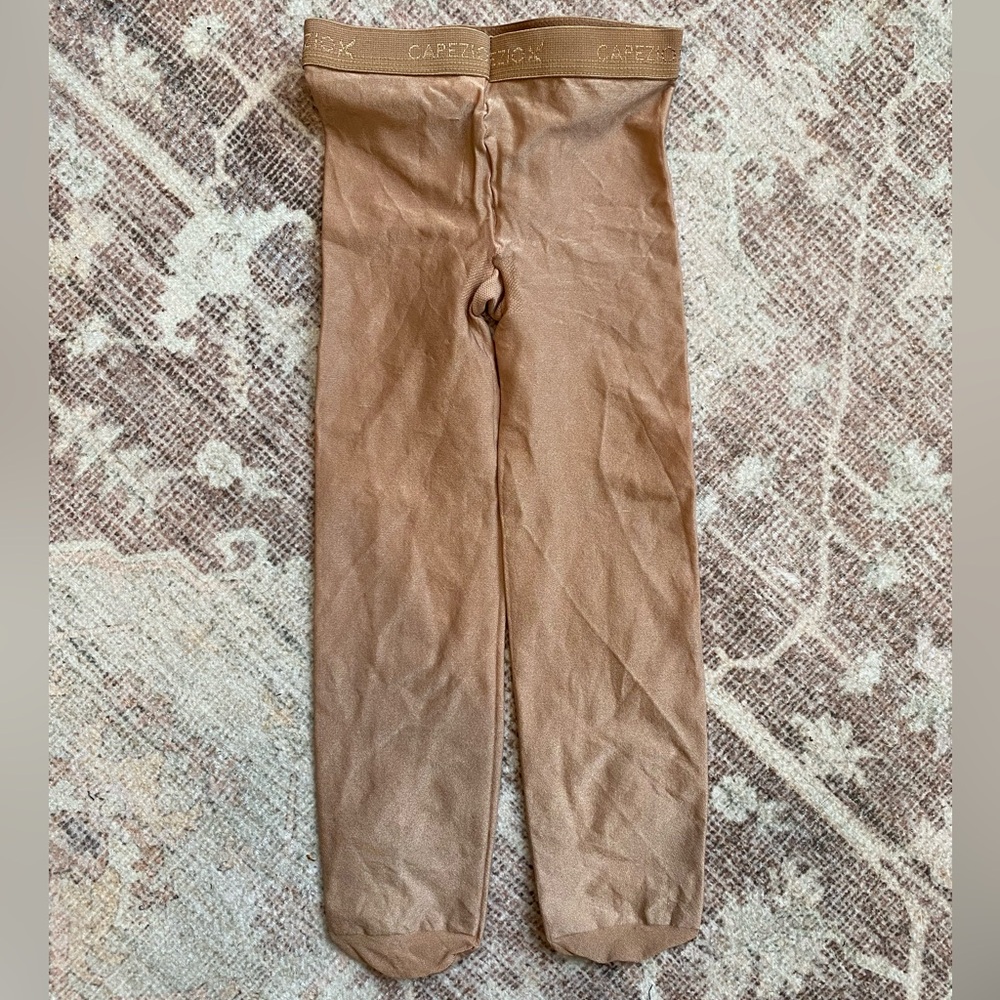 Capezio child ultra shimmery footed tight in suntan, size M/S
